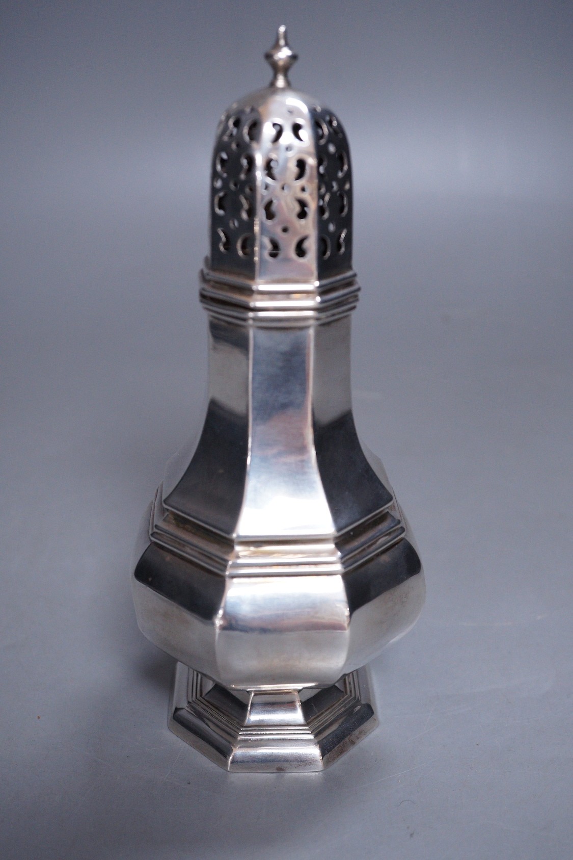 A George V silver octagonal sugar caster, Henry Wigfull, Sheffield, 1924, 18cm, 169 grams.